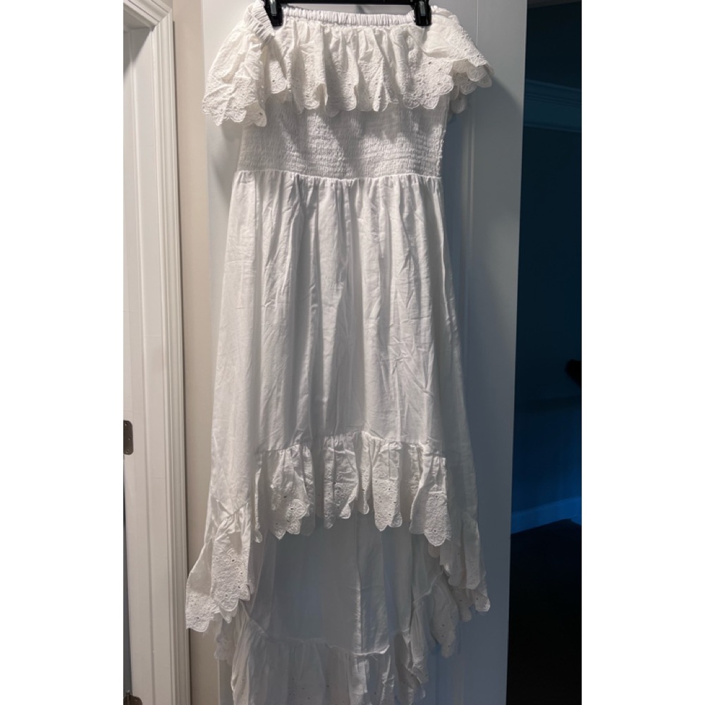 Smocked off shoulder white dress with high low hem.